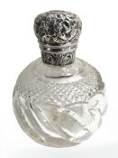 A silver lidded crystal perfume bottle,
