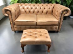 A contemporary Chesterfield two seater club settee in deep buttoned and studded tan leather,