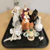 A group of figurines including Goebel, Nao, a Beswick brown gloss horse, a Wedgwood Angela vase.