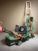 A Qualcast electric garden mower, an extension reel, length of garden hose,