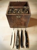 An oak box of assorted antique cutthroat razors.