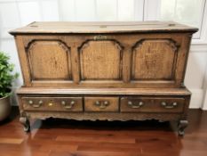 A George III panelled oak mule chest, 145 cm x 54 cm x 90 cm.
