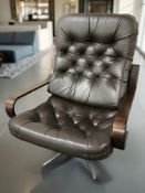 A contemporary swivel armchair on metal support