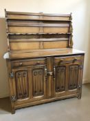 An oak linen fold dresser, 132 cm x 52 cm x 156 cm.