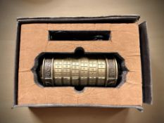 A reproduction Da Vinci combination locking cylindrical box.