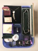 A group of silver pendants including a simulated opal and cubic zirconia cluster pendant,