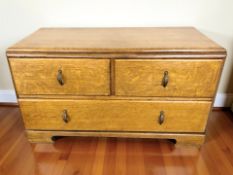 A 1930's oak three drawer low chest,