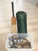 A vintage cricket bat, several horse shoes, vice,