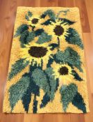 A 1970's shaggy piled rug depicting Van Gogh's 'Sunflowers', 112 cm x 74 cm.