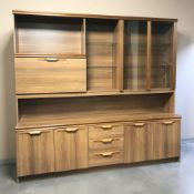 A teak effect wall unit, 194 cm x 45 cm x 183 cm.