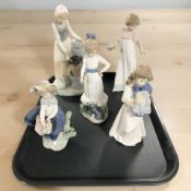 Four Nao figures of girls and a further Lladro figure of a girl with a flower basket.