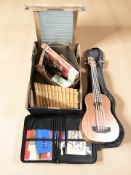 A Countryman UB electric bass ukulele, with gig bag, a wooden xylophone, a leather pouch,
