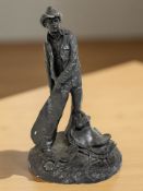 A Michael Garman bronze effect sculpture depicting a cowboy, height 40 cm.