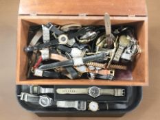 A mahogany table box containing a large quantity of lady's and gent's wristwatches including Casio,