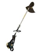 A petrol brush cutter / grass strimmer.