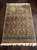 A machine made rug of Iranian design, 187 cm x 115 cm.