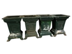 A set of four painted metal classical style garden planters on paw feet, each 70 cm high.