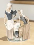 A large Nao figure group of two women by a well, height 40 cm.