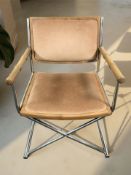 A metal framed chair with faux bamboo arm rests.