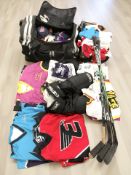 Assorted ice hockey shirts, protective clothing, three sticks.