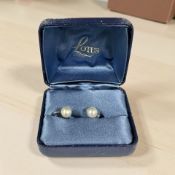 A pair of lotus pearl earrings with 9ct gold screw backs.