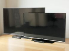 A Hitachi 49 inch LCD TV and a JVC TV with leads and remotes