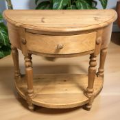 A contemporary pine demilune hall table, fitted a drawer, width 94 cm.