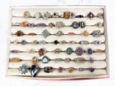 Fifty-six gem-set dress rings including many silver examples, including emeralds,