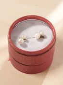 A pair of 9ct gold backed cultured pearl earrings with post fittings.