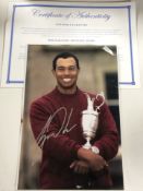 A signed photograph of Tiger Woods, with certificate of authenticity, 30 cm x 20 cm.