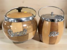 A wooden swing handled biscuit jar with stainless steel mounts, height 17 cm, and a similar tea jar.