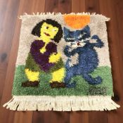 A 1970's shaggy piled rug depicting a girl and a cat, 112 cm x 100 cm.