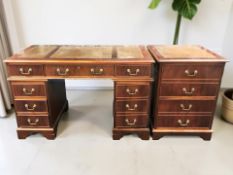 A reproduction mahogany effect twin pedestal writing desk with tooled leather inset top,