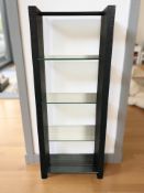 A modern open bookcase with glass shelves,