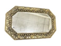 An early 20th century brass embossed bevelled mirror,