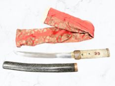 A reproduction Japanese tanto dagger in sheath.
