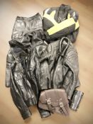 A group of leather motorcycle jackets, stitched leather bags, etc.