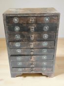 A reproduction oriental style metal mounted eight drawer miniature chest, height 34 cm.