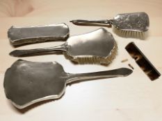 A silver-backed three-piece dressing table brush and mirror set,