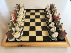 An Elizabethan style chess set, kings 12.5 cm, together with a chess board.