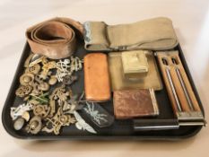 Assorted items including military cap badges, leather belt, canvas belt, a brass ink well,