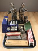 A patinated metal figure of a blacksmith, similar figure of a miner, miniature miner's lamp,