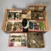 A collection of costume jewellery, empty perfume bottles,