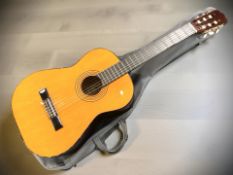 A classical guitar with soft carry bag