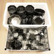 A quantity of French black glass plates and dishes,