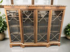 An early 20th century mahogany break front four door bookcase with astral glazed doors,