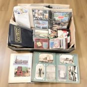 Several albums of antique and later postcards, various stamps, photographs,