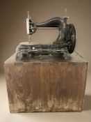 An antique Jones sewing machine in wooden box.