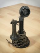 A Bakelite candlestick telephone.