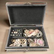 A reproduction jewellery casket containing assorted costume necklaces, earrings, paste items,